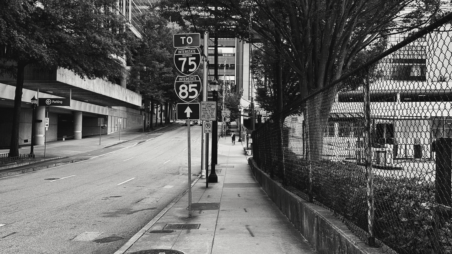 An empty Atlanta street, the signs pointing to 75 and 85.