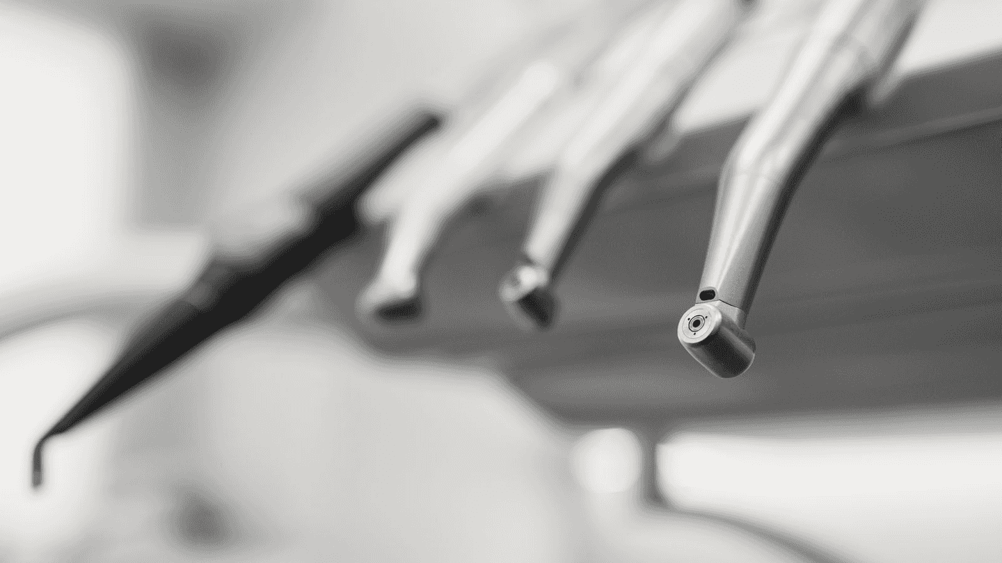 Dental instruments on their arm, close.